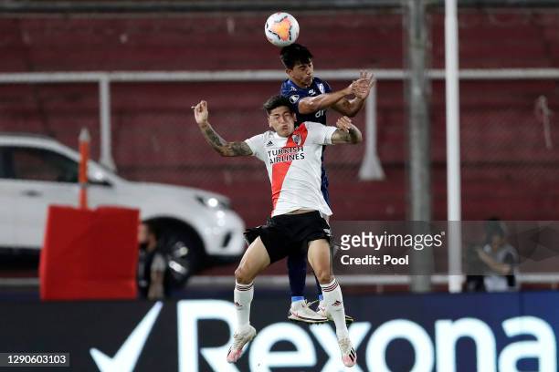 Armando Méndez of Nacional jumps for a header with Jorge Carrascal of River Plate during a first leg match between River Plate and Nacional as part...