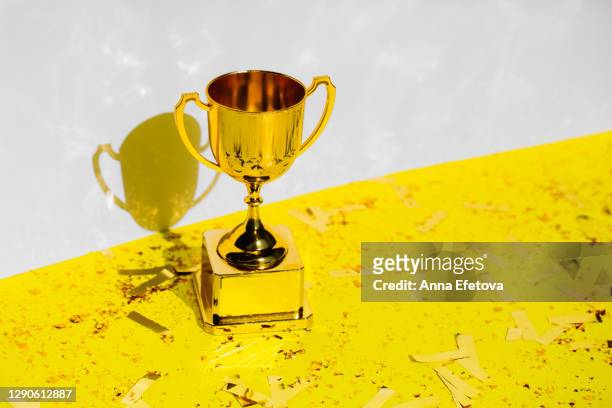 golden champions cup. trendy colors of 2021 year - preisverleihung stock-fotos und bilder