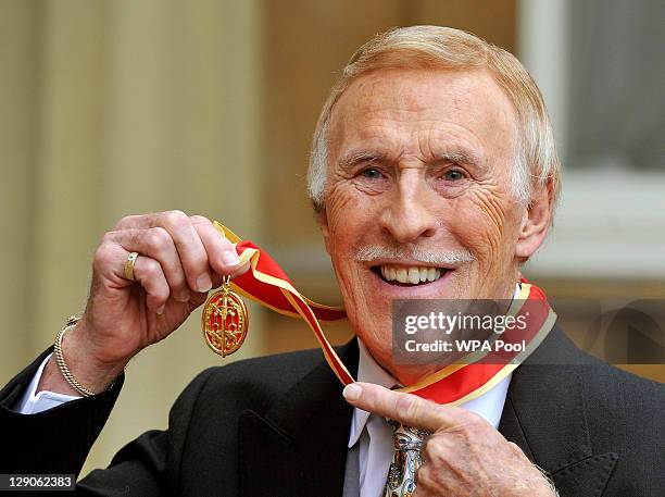 Sir Bruce Forsyth poses after he was knighted by Queen Elizabeth II at Buckingham Palace on October 12, 2011 in London, England. The Strictly Come...