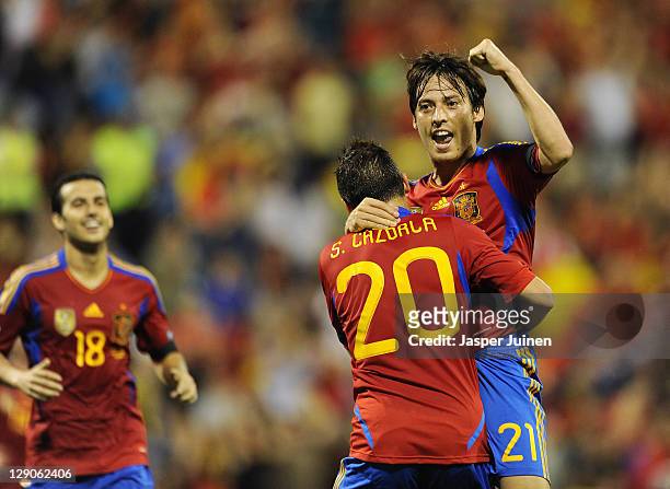 David Silva of Spain celebrates scoring his sides second goal with his teammate Santi Cazorla and Pedro Rodriguez during the UEFA EURO 2012 Group I...