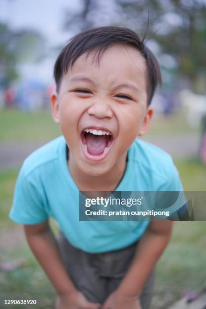 little boy laughing with mouth open wide - boy thailand stock pictures, royalty-free photos & images