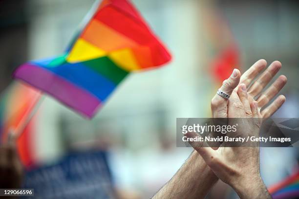lgbt rinbow flag and clapping hands - gay pride parade stockfoto's en -beelden
