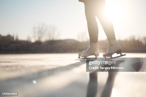 closeup view of woman ice-skates and ice - ice skating stock pictures, royalty-free photos & images