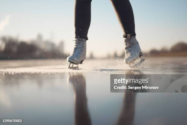 closeup view of woman ice-skates and ice - figure skating woman stock pictures, royalty-free photos & images