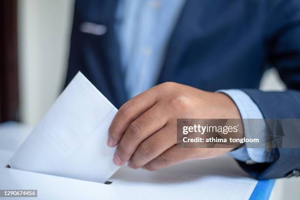 ballot box with person casting vote. - voting by mail stock pictures, royalty-free photos & images