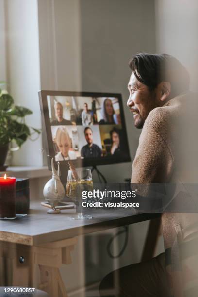 happy asian man at virtual christmas party - working from home stock pictures, royalty-free photos & images