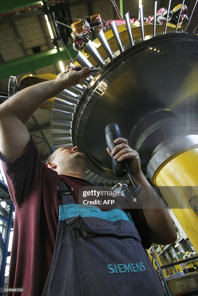 An employee works on the rotor of a Siem