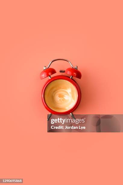 red alarm clock with empty coffee inside - morning coffee stock pictures, royalty-free photos & images