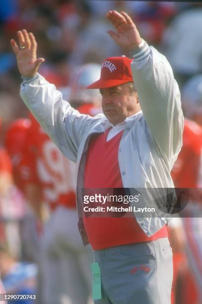 Head coach Earle Bruce of the Ohio State Buckeyes signals his players before a college football game against theMichigan State Spartans on October...