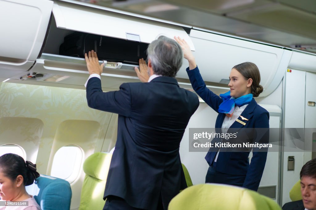 Stewardess service to businessman in first class.