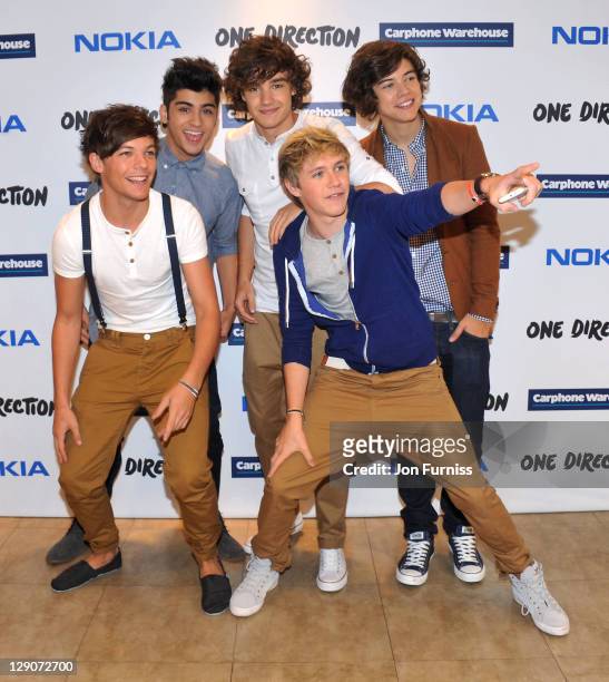 Louis Tomlinson, Zayn Malik, Liam Payne, Niall Horan and Harry Styles of One Direction launch their new Nokia handsets at The Carphone Warehouse on...