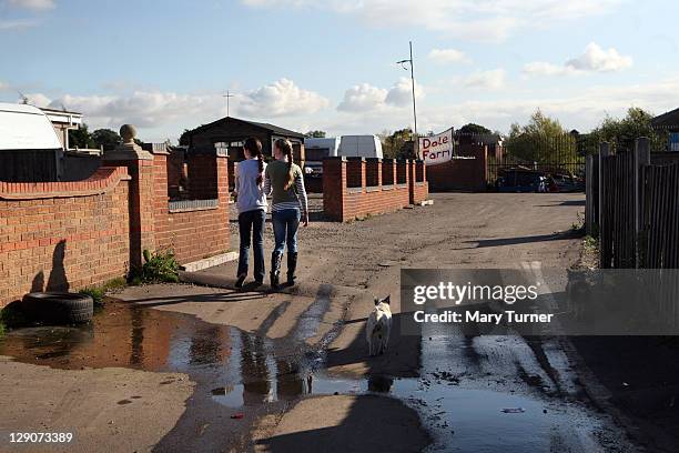 Travellers Eileen and Vallen Sheridan walk through Dale Farm Travellers camp on October 12 2011, near Basildon, England. After years of protracted...
