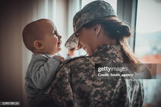 woman soldier meeting her baby boy after a long time - military uniform stock pictures, royalty-free photos & images