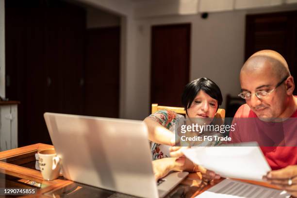 couple doing finances or working together at home - dwarf stock pictures, royalty-free photos & images