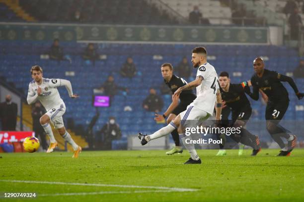 Mateusz Klich of Leeds United scores their sides first goal from the penalty spot after VAR awarded a retake during the Premier League match between...