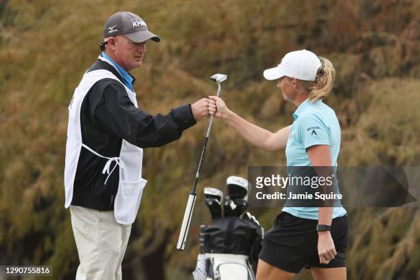 Stacy Lewis of the United States celebrates with her caddie, Travis Wilson, after making a putt for birdie on the 18th green during the second round...
