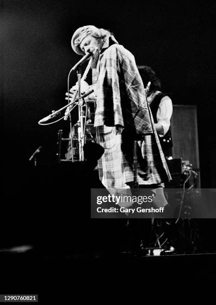 Scottish Rock musician Ian Anderson, of the group Jethro Tull, plays flute as he performs onstage, during the band's 'Heavy Horses' tour, at Madison...