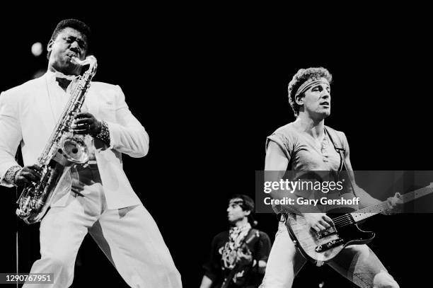 American Rock musicians Clarence Clemons of the E Street Band, on saxophone, and Bruce Springsteen, on guitar, perform onstage during the 'Born in...