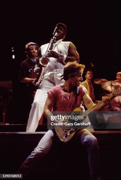 American Rock musician Bruce Springsteen plays guitar as he performs onstage, with the E Street Band, during the 'Born in the USA' tour, at Giants...