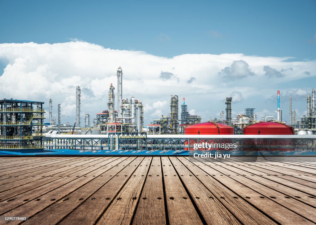 Wooden platform and petrochemical Plant, Zhanjiang City, Guangdong Province, China.
