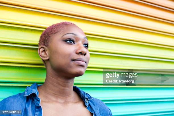 confident portrait of teenager against multi-colored wall - determination face stock pictures, royalty-free photos & images
