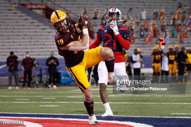Wide receiver Ricky Pearsall of the Arizona State Sun Devils catches a 31-yard touchdown reception past defensive back of the Arizona Wildcats during...