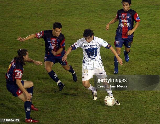 Rubens Sambueza of Pumas fights for the ball with Christian Bermudez, Daniel Guerreo and Andres Carevic of Atlante during the final match of the 2007...
