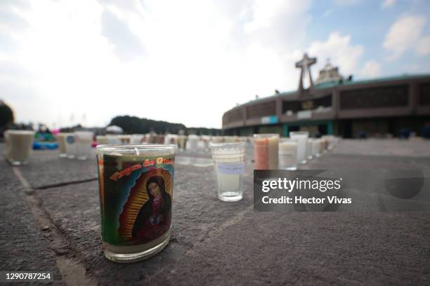 Candles carrying messages left by parishioners are light up in the area of the Basilica as part of the Day Of Our Lady Of Guadalupe Celebrations at...