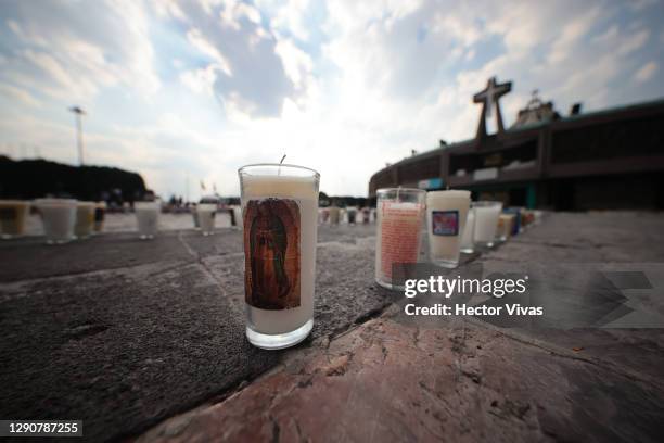 Candles carrying messages left by parishioners are light up in the area of the Basilica as part of the Day Of Our Lady Of Guadalupe Celebrations at...