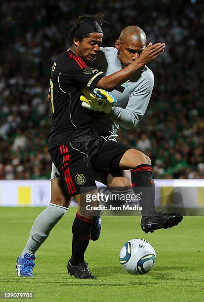 Giovani dos Santos of Mexico struggles for the ball with Jefferson de Oliveira of Brasil during a friendly match between Mexico National Team and...