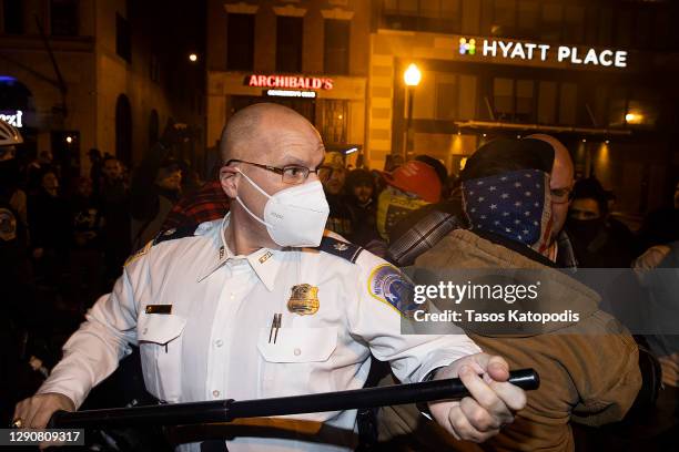 Washington DC Police keep Members of the Proud Boys back as they clash with Black Lives Matter protesters during a protest near Black Lives Matter...