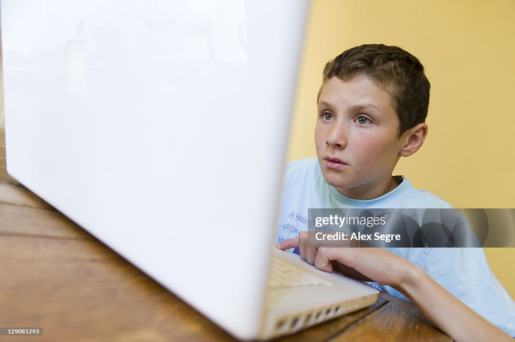 Child using Apple laptop computer