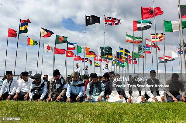 Muslims pray under flags at the 45th Jalsa Salana, Ahmadiyya Annual Convention held at Oakland Farm near Alton, Hampshire, 24th July 2011. The...