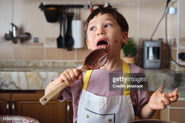 cute child making cake at kitchen - spion stock pictures, royalty-free photos & images