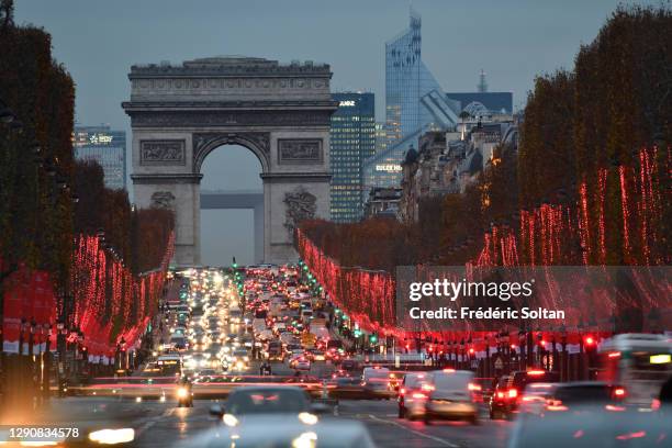 Illuminations on the Champs Elysees Avenue at night and Arc de Triomphe in Paris on December 10, 2020 in Paris, France.