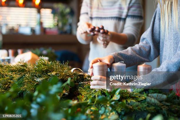 woman and child making an advent wreath, close-up of hands - münchen advent stock pictures, royalty-free photos & images