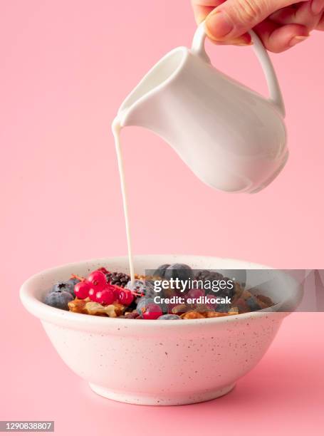 healthy breakfast with muesli and berries - pouring cereal stock pictures, royalty-free photos & images