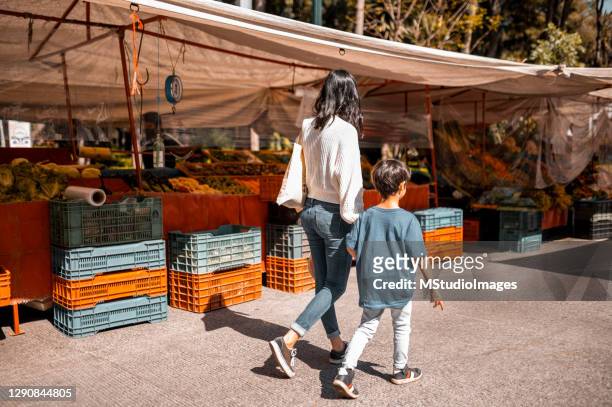 mother and son enjoying the walk - mexico market stock pictures, royalty-free photos & images