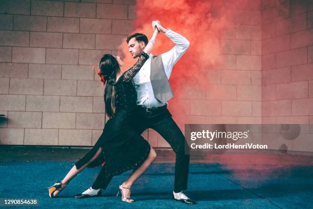 young couple dancing on stage - latin american dancing stock pictures, royalty-free photos & images