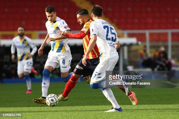 Massimo Coda of Lecce marked by Marcos Curado of Frosinone and Przemyslaw Szyminski of Frosinone during the Serie B match between US Lecce and...