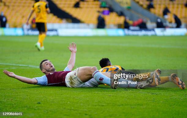 John McGinn of Aston Villa reacts as he is brought down by Nelson Semedo of Wolverhampton Wanderers inside the penalty area, before Aston Villa are...