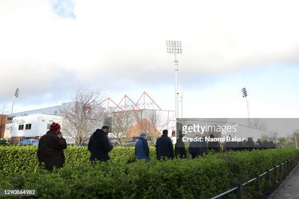 General view outside the stadium as fans form a socially distanced queue as they wait to enter the stadium prior to the Sky Bet Championship match...