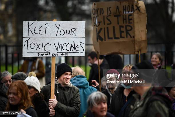 Protesters with placards march from the Scottish Parliament to Bute House on December 12, 2020 in Glasgow, Scotland. The group, known as Saving...