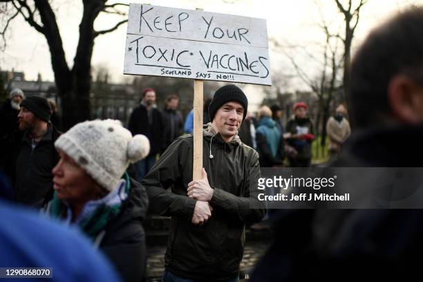 Protesters with placards march from the Scottish Parliament to Bute House on December 12, 2020 in Glasgow, Scotland. The group, known as Saving...