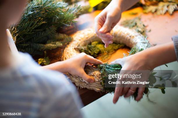 woman and child making an advent wreath, close-up of hands - münchen advent stock pictures, royalty-free photos & images