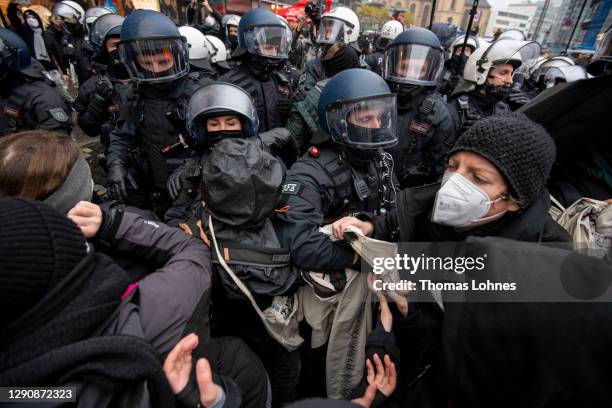 Police officers push left-wing Antifa counter demonstrators back while the demonstrat against opponents of what they claim are restrictions to their...