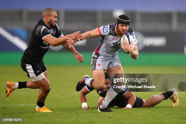 Leigh Halfpenny of Scarlets holds off the challenge of Jonathan Joseph of Bath during the Heineken Champions Cup Pool 1 match between Bath Rugby and...