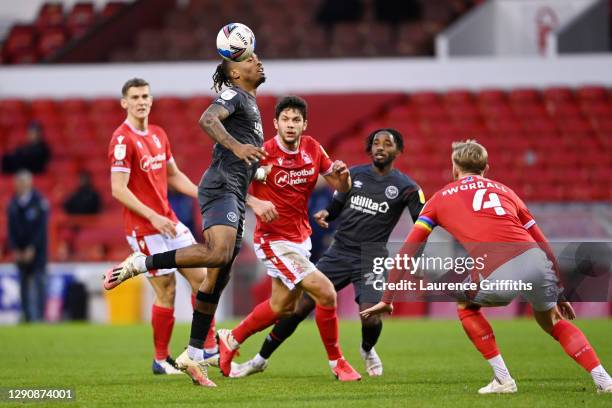 Ivan Toney of Brentford heads the ball under pressure from Tobias Figueiredo of Nottingham Forest during the Sky Bet Championship match between...