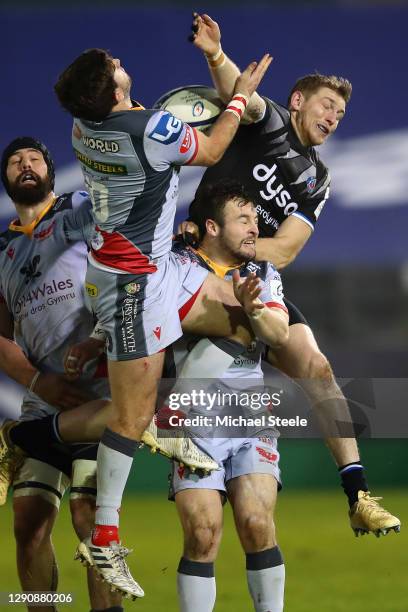 Ruaridh McConnochie of Bath battles for a high ball with Dan Jones and Steff Hughes during the Heineken Champions Cup Pool 1 match between Bath Rugby...