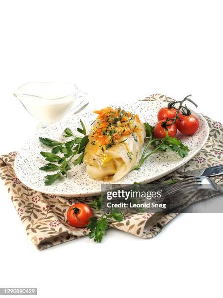 food photography of diet dish, steamed stuffed cabbage roll with filling of minced meat, rice and spices side view, served with vegetables and herbs on white background isolated close up - cabbage roll stock pictures, royalty-free photos & images